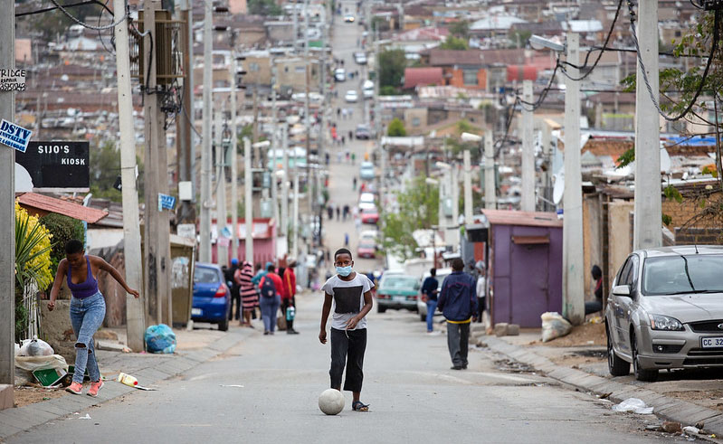 A boy kicks a soccer ball up the street during lockdown in Alexandra Township, Johannesburg.     