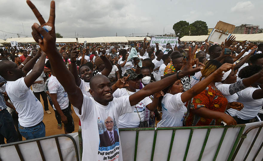 Supporters of Michel Gbagbo, the eldest son of the former ousted Ivorian president, and candidate in the uncoming March 6 legislative elections, cheers as he arrive at La Place Figayo de Yopougon, a district of Abidjan on February 27, 2021. Photo: Sia Kambou/AFP