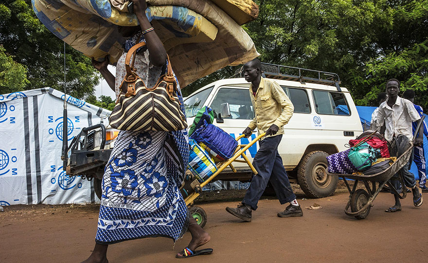 Internally Displaced Persons in the capital of South Sudan relocate to a cleaner, drier location across town, under the protection of the United Nations Mission in South Sudan (UNMISS).
