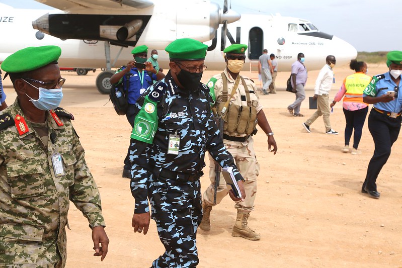 AMISOM officers walking in an airfield. 