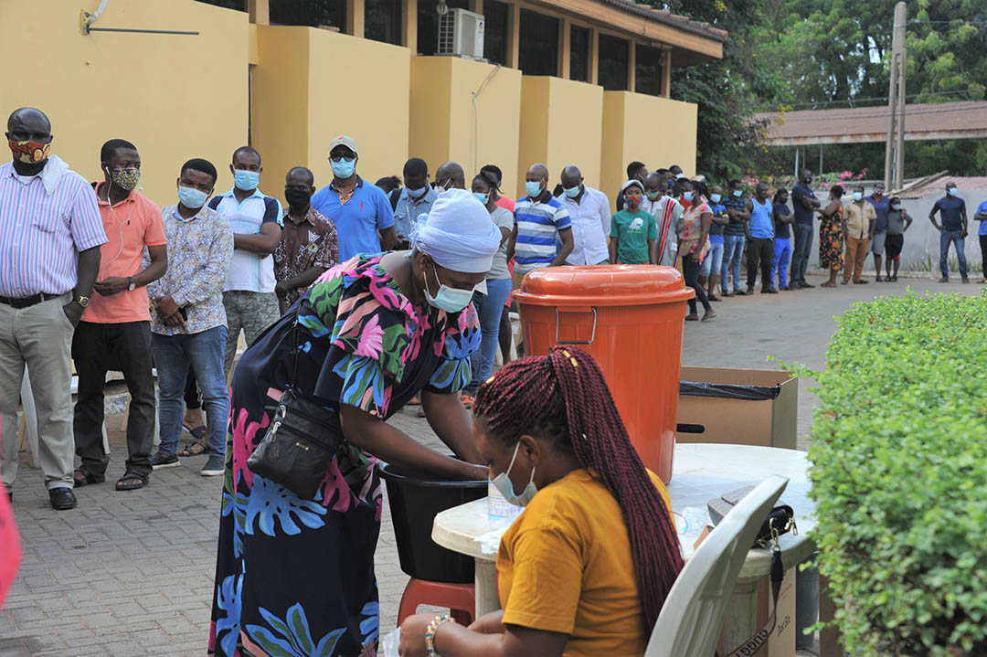 A woman washes her hands before voting at a polling station in Accra, Ghana.
