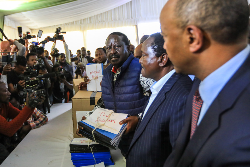 Kenya's opposition leader Raila Odinga (C) arrives to file his petition challenging the result of the elections