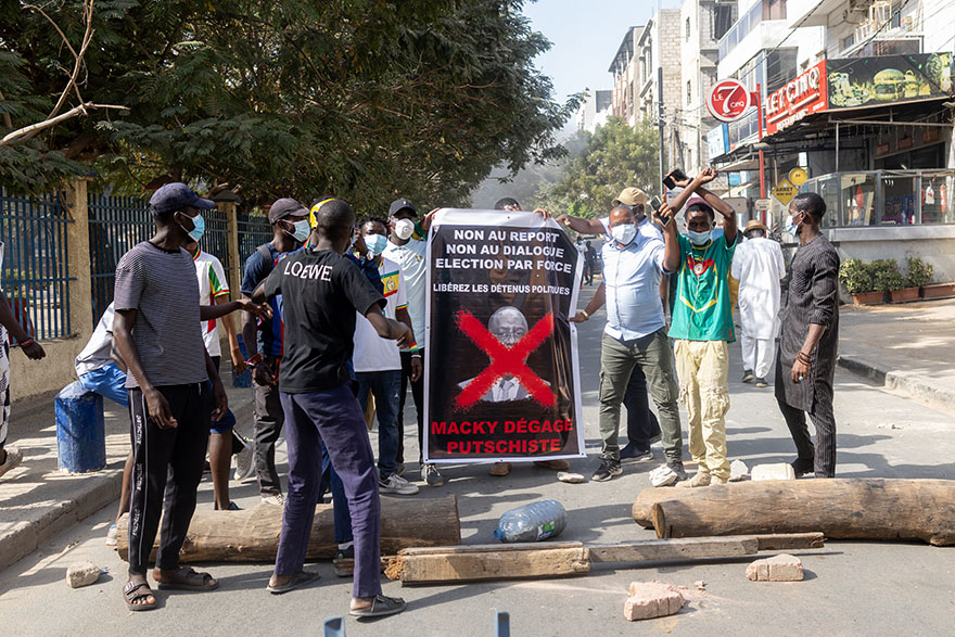 Protesters display a banner that reads “Macky, putschist, get out” during a protest in Senegal’s capital Dakar on 9 February, after Senegal's president Macky Sall postponed the presidential elections, originally scheduled for 25 February. Photo: Jerome Favre