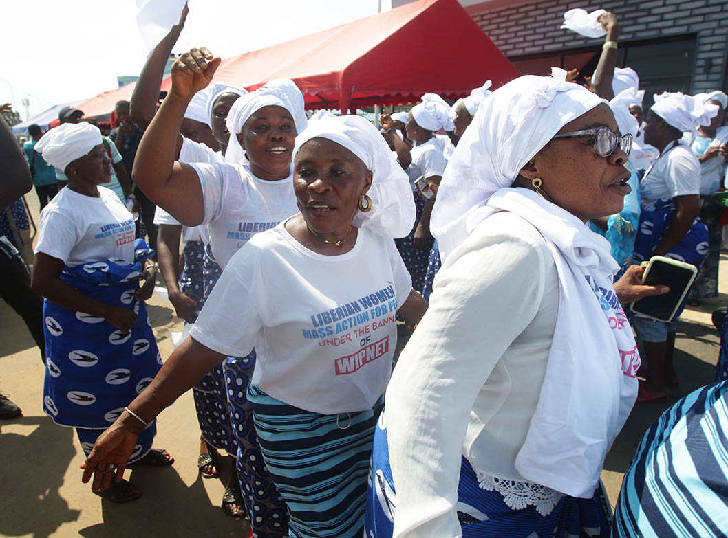 Monrovia, Liberia, June 2022. People celebrating a mass Action for peace, organised by the Women in Peacebuilding Network (WIPNET) of the West Africa Network for Peacebuilding (WANEP). Photo: Ahmed Jallanzo, EPA.