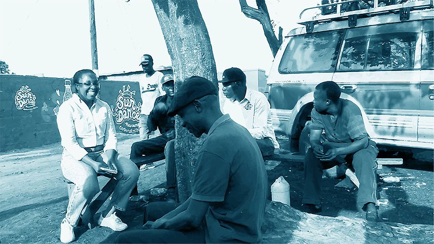 Patience Mususa, co-editor of the book, in conversation with a group of young men in Lusaka, Zambia, while doing field studies for the research that informs the book project on DIY Urbanism.