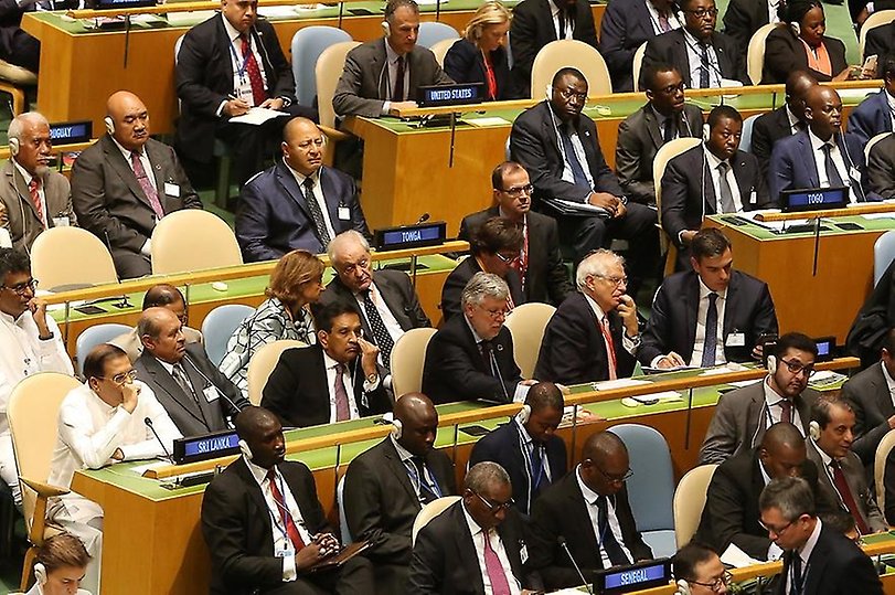 Representatives from 20+ different countries sitting and listening during a session of the United Nations General Assembly