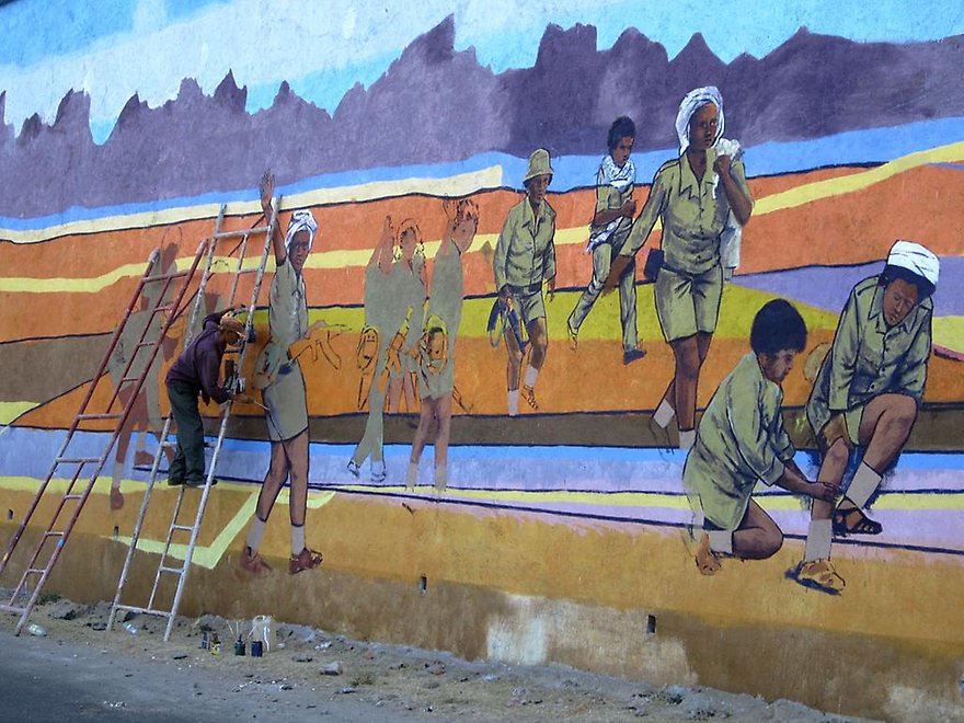 An artist prepares a patriotic mural by the road between Asmara and Keren.