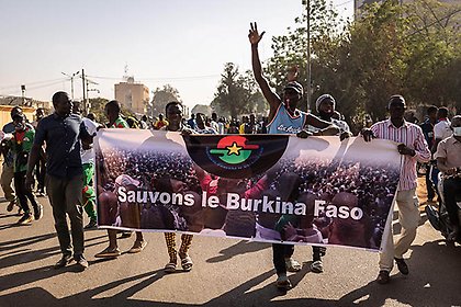 Protestors hold a banner reading 'Save the Burkina Faso' during a demonstration in Ouagadougou on November 27, 2021.