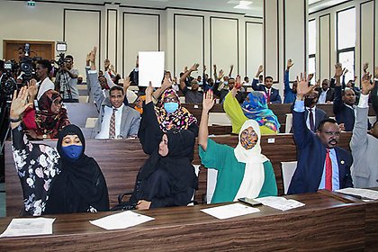 Somalian members of parliament hold up their hands at a special assembly on the abandonment of the two-year extension of the presidential term and immediate elections to ease the political crisis. 