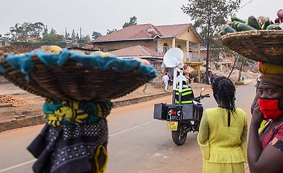 A policeman transmits information about Covid-19 preventive measures on a street in Kigali. Photo: Cyril Ndegeya/Xinhua